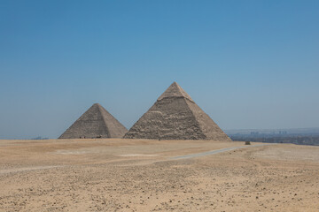 Fototapeta na wymiar The Great Pyramids of Giza near the ruins of a temple in Giza, Egypt