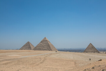 Fototapeta na wymiar The Great Pyramids of Giza near the ruins of a temple in Giza, Egypt