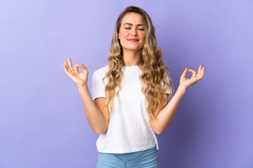 Fototapeta premium Young Brazilian woman isolated on purple background in zen pose