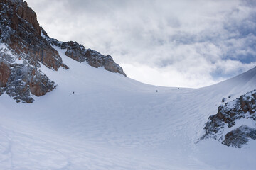 Heliski in winter in the mountains a lot of snow and blue sky