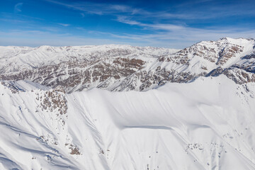 High snowy mountains in winter and blue skies