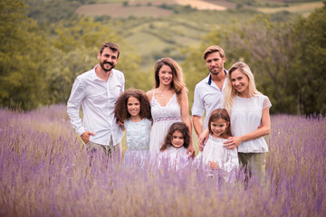 Fototapeta premium Large group of people standing in lavender filed.