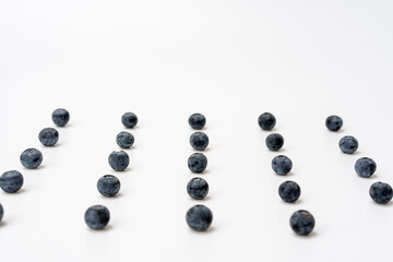 Blueberries are neatly arranged on a white background