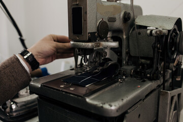 man on sewing machine