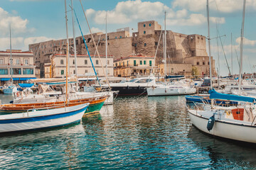  Castel Dell'ovo Or Egg Castle a medieval fortress located in the Gulf of Naples. Famous historical mediterranean coast fortress port. Colorful buildings, yachts and boats
