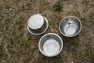 an iron animal bowl lies on the grass