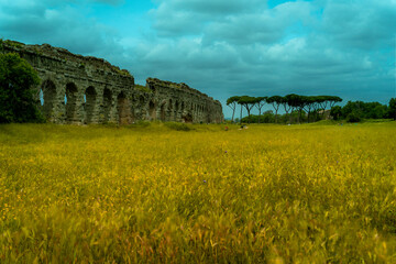 The Parco degli Acquedotti during a cloudy day with dramatic sky, a public archaeological park in Rome, part of the Via Appia Regional Park, with monumental remains of Roman aqueducts