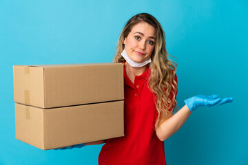 Young delivery woman isolated on white background making doubts gesture while lifting the shoulders
