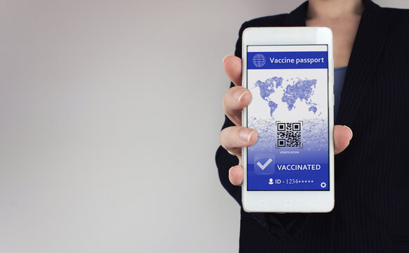 Covid-19 vaccine passport concept. Digital vaccination certificate for COVID-19 on smarfone in hand. Corona virus vaccine passport on mobile phone device