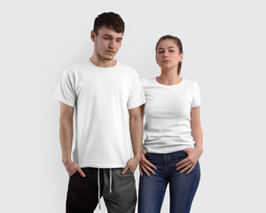Fototapeta na wymiar Mockup of a white t-shirt on a girl and a guy, isolated on background in the studio, clothes for design, front view set