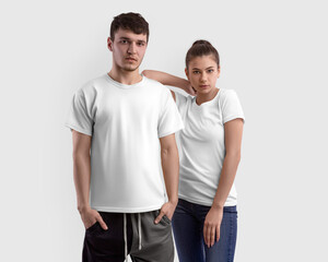 Mockup of a white t-shirt on a girl and a guy, isolated on background in the studio, clothes for design, front view set