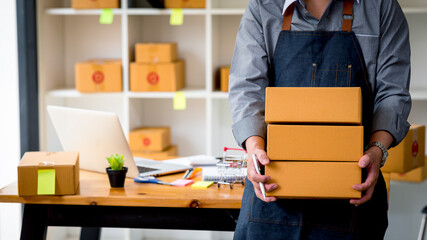 Starting small businesses SME owners man entrepreneurs Write the address on receipt box and check...