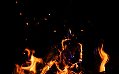 Fototapeta na wymiar Bright burning flame of fire on a black background, beautiful abstract background and texture