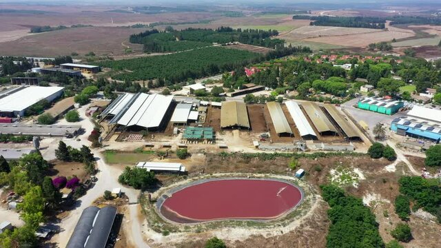 Aerial Shot Of Reservoir And Buildings, Drone Flying Backward At Kibbutz - Megiddo, Israel