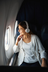 Contented lady looking at the clouds during the flight © Viacheslav Yakobchuk