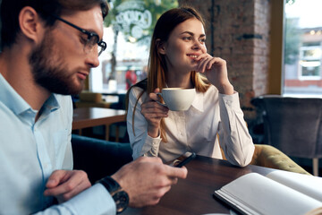 business men and woman sitting in a cafe a cup of coffee leisure communication
