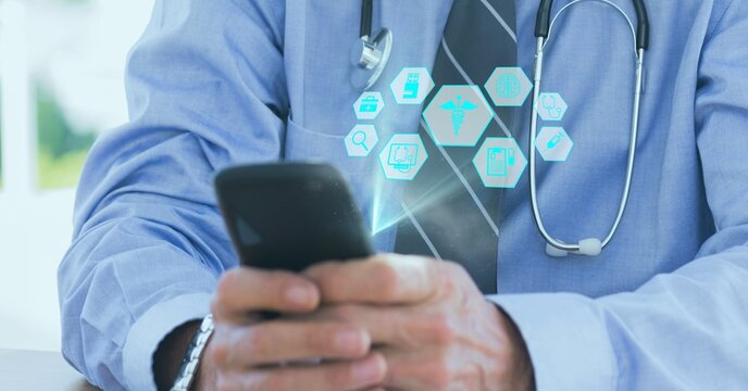Composition of network of medical icons over male doctor using smartphone