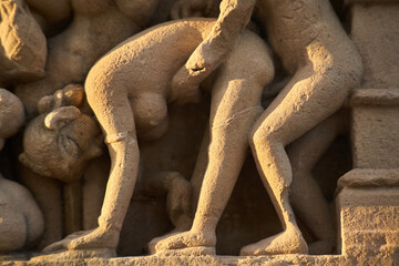 Erotic scenes from the temple frieze in Khajuraho/India.Reproduction is the production of new, independent offspring of a living being. The union here is not primarily a physical act, but a spiritual  - obrazy, fototapety, plakaty