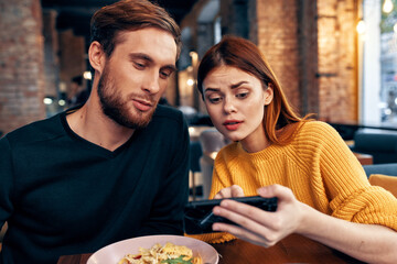 happy man and woman in cafe fun friends food