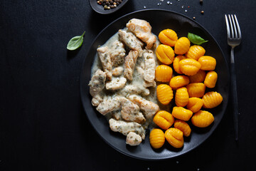 Sweet potato gnocchi with chicken on plate