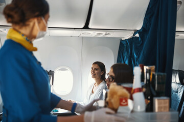 Positive passenger and cabin hostess exchanging looks