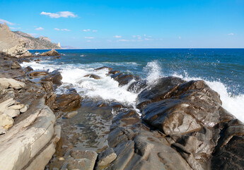 Rocky coast of Crimea . Splashing waves of Black Sea . Kutlakskaya Buhta in Vesele Crimea - obrazy, fototapety, plakaty