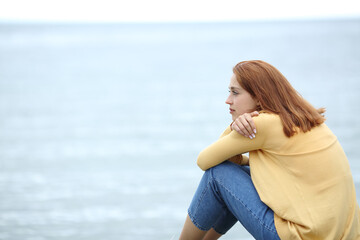 Fototapeta na wymiar Woman contemplating on the beach