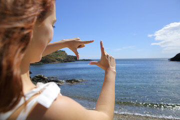 Woman faming with hands on the beach