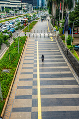 Jakarta traffic along Jendral Sudirman street , Central Business District of Jakarta, Indonesia capital city, in the afternoon on weekday 