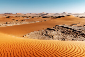 Dried ground with sand in Namib desert during sunset