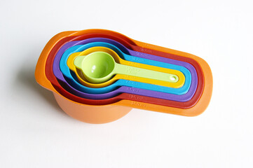 A set of measuring spoons made of colored plastic.
