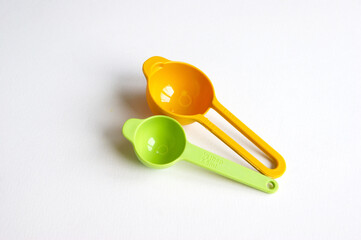 A set of measuring spoons made of colored plastic.