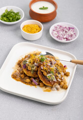 Aloo Tikki or Cutlet or Aloo Patties  dipped in Chickpea curry