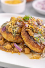 Aloo Tikki or Cutlet or Aloo Patties  dipped in Chickpea curry