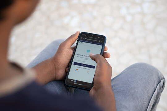 Indian Teenager Registering Himself To Get Vaccinated Using His Mobile Phone Via Cowin Platform And Booking His Appointment For Vaccination