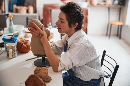 Process of carving facial details on clay model