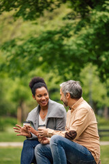 People holding cups of coffee, while spending day together.