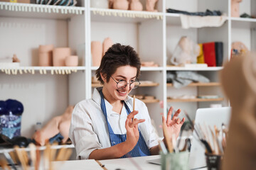 Delighted pottery designer feeling happy of her sketch