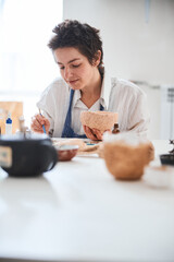 Process of clay pot painting by female pottery designer