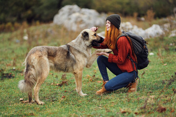 woman hiker backpack travel friendship walking the dog fun mountains