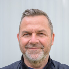 Happy middle-aged man looking at camera