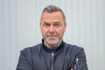 Sincere middle-aged man looking at camera with empathy