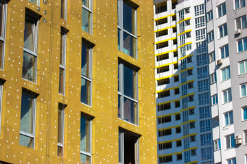 Warming of a facade of a multi-story residential building with a mineral, rock wool. External...