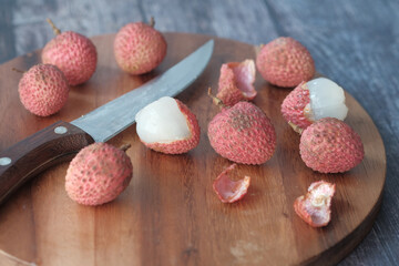 Lychee on a chopping board on table 