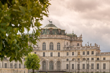 Fototapeta na wymiar Stupinigi, Turin, Italy: historic royal hunting lodge of the Savoy royal house, selective focus blurred leaves in the foreground