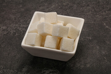 Refined white sugar cubs in the bowl