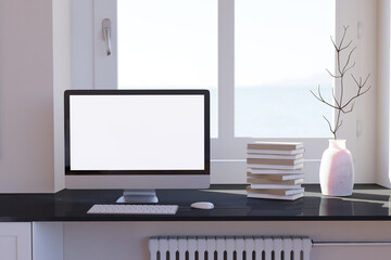 Blank computer desktop with keyboard on table at window, books on marble table in sunny room, mockup