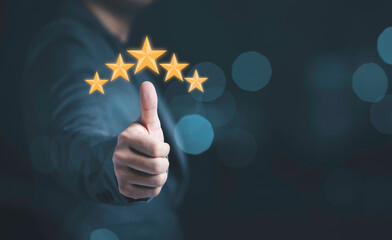 Businessman hand thumb rise up with yellow stars for customer satisfaction and product service...