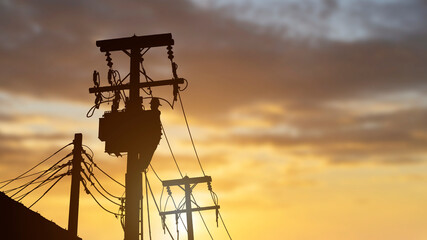 silhouette technicians work on high voltage transformers.