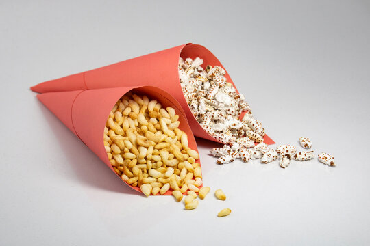 puffed rice and popped rice in pink paper packet on white background studio shoot.